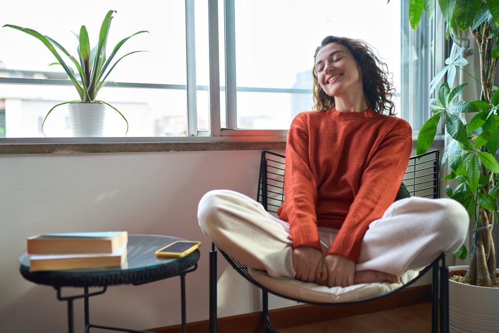 Ladding sitting on a chair enjoying the compfort of her energy efficient house